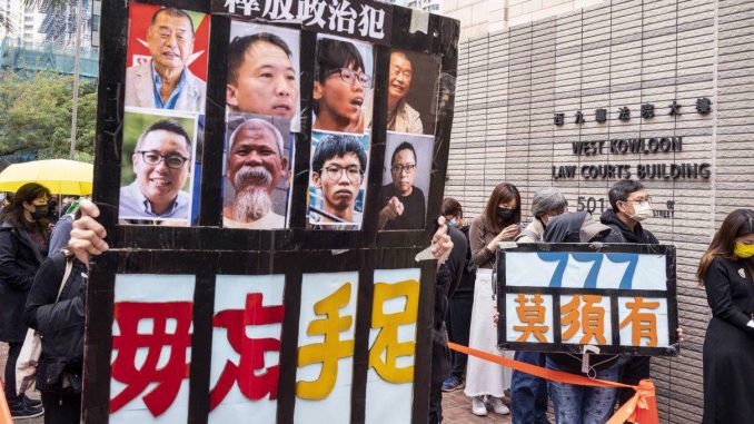 Pro-democracy protesters hold placards in support of the