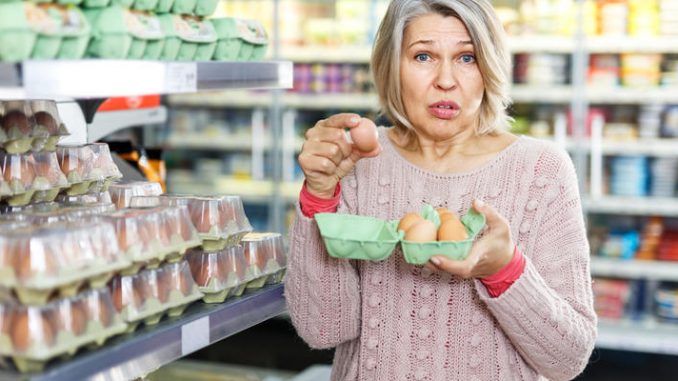 Mature woman shopping eggs