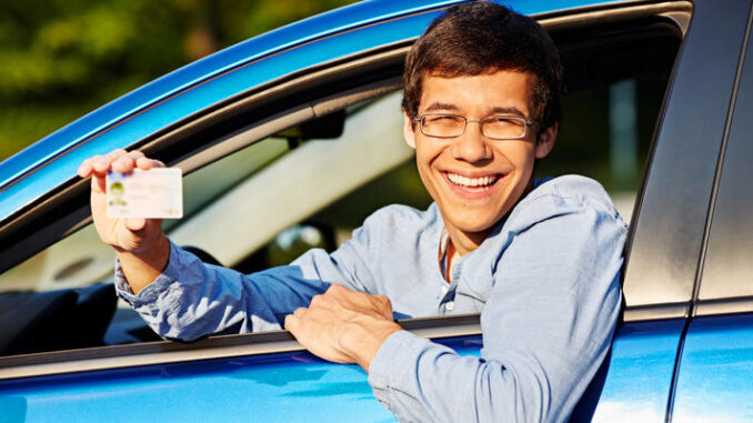 Guy shows driving license from car