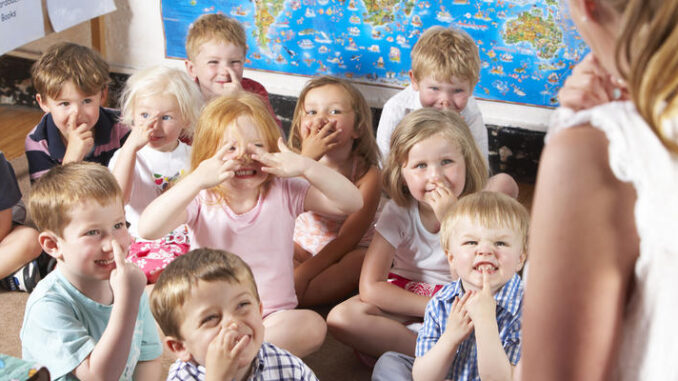 Montessori/Pre-School Class Listening to Teacher on Carpet