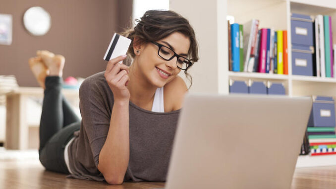 Happy woman doing online shopping at home